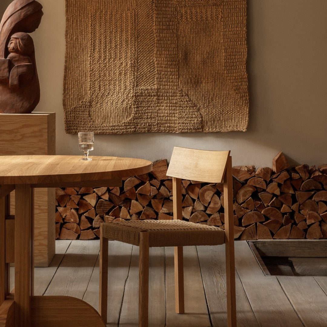 Natural wood tones with textured beige wall art; serene, earthy palette in a cozy interior setting.