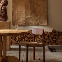 "Warm wood tones with textured wall art; earthy colors and natural materials create a cozy aesthetic."
