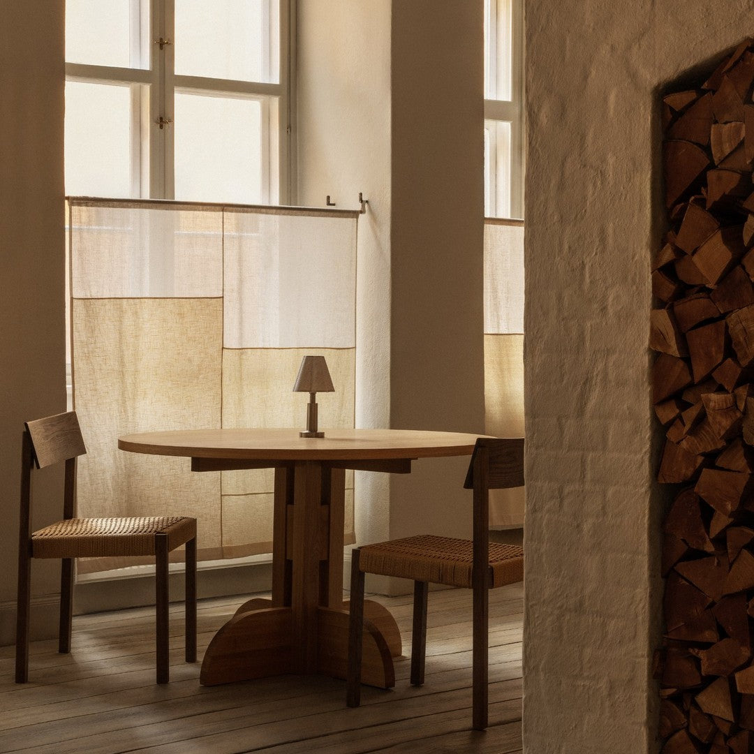 Warm beige and soft brown tones with a minimalist pattern, showcasing a cozy dining setup in natural light.