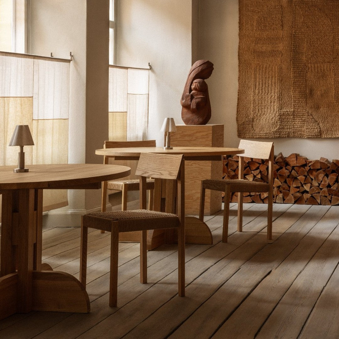 Warm wood tones and earthy textures create a cozy, inviting interior with neutral hues and rustic patterns.