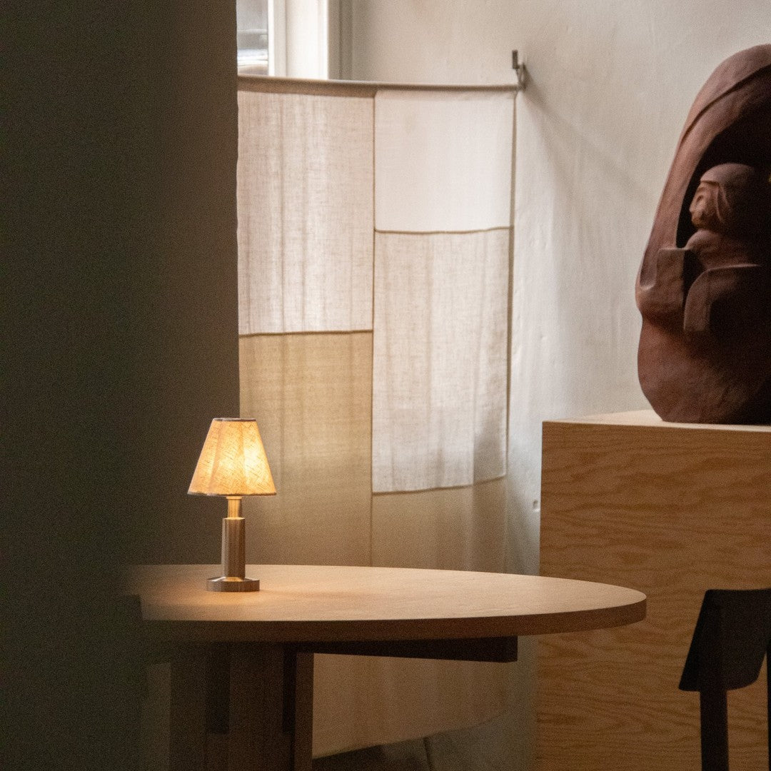 Neutral tones with a soft beige and subtle texture in a cozy interior setting, featuring a warm glow from a lamp.