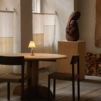 "Neutral tones and earthy textures in a minimalist interior featuring light fabrics and organic decor."