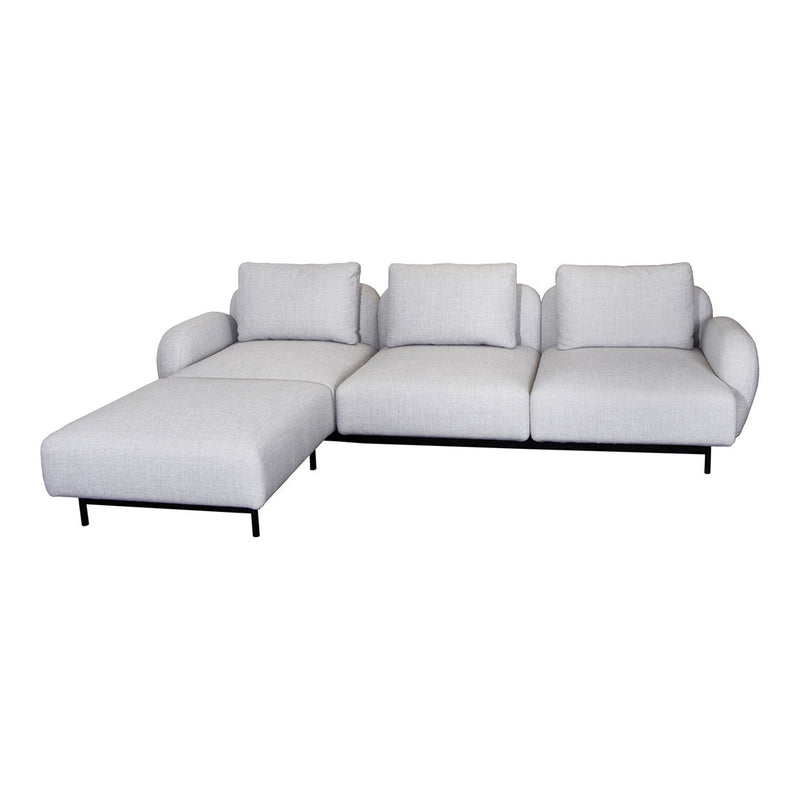 Light gray modern sectional sofa with plush cushions and sleek black metal legs. Stylish and minimalist design.