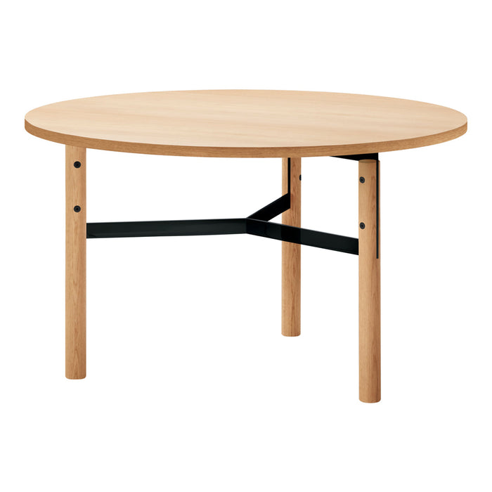 Natural wood grain round table with light beige surface and black metal accents. Simple, modern design.