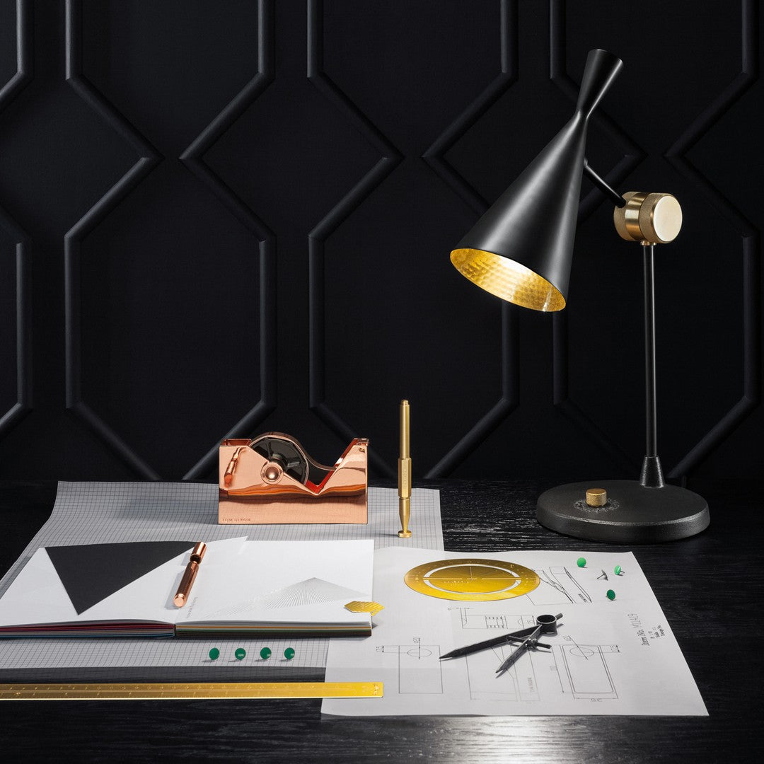 Modern black and gold desk setup featuring geometric patterns and sleek design elements.