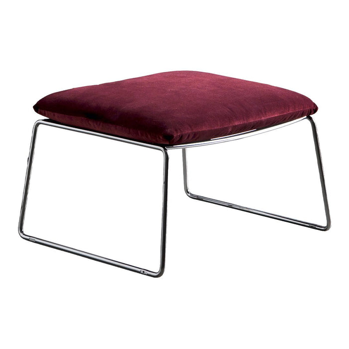 Burgundy velvet ottoman with sleek chrome legs, perfect for modern decor.