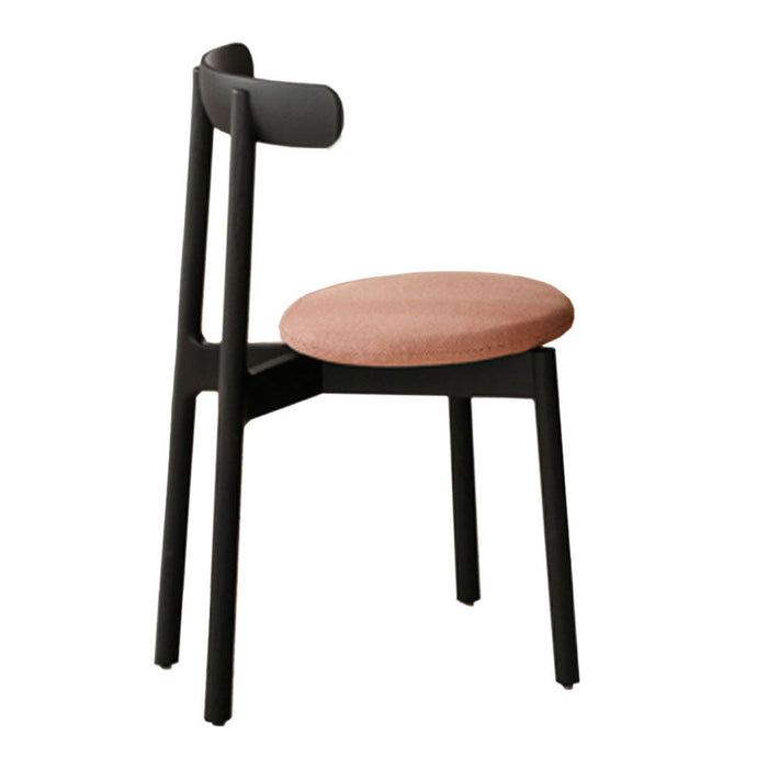 Modern chair featuring black wood frame and textured peach seat upholstery. Stylish and contemporary design.