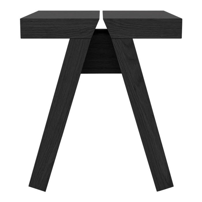 Black wooden side table with a sleek, modern design and unique geometric patterns in the legs.