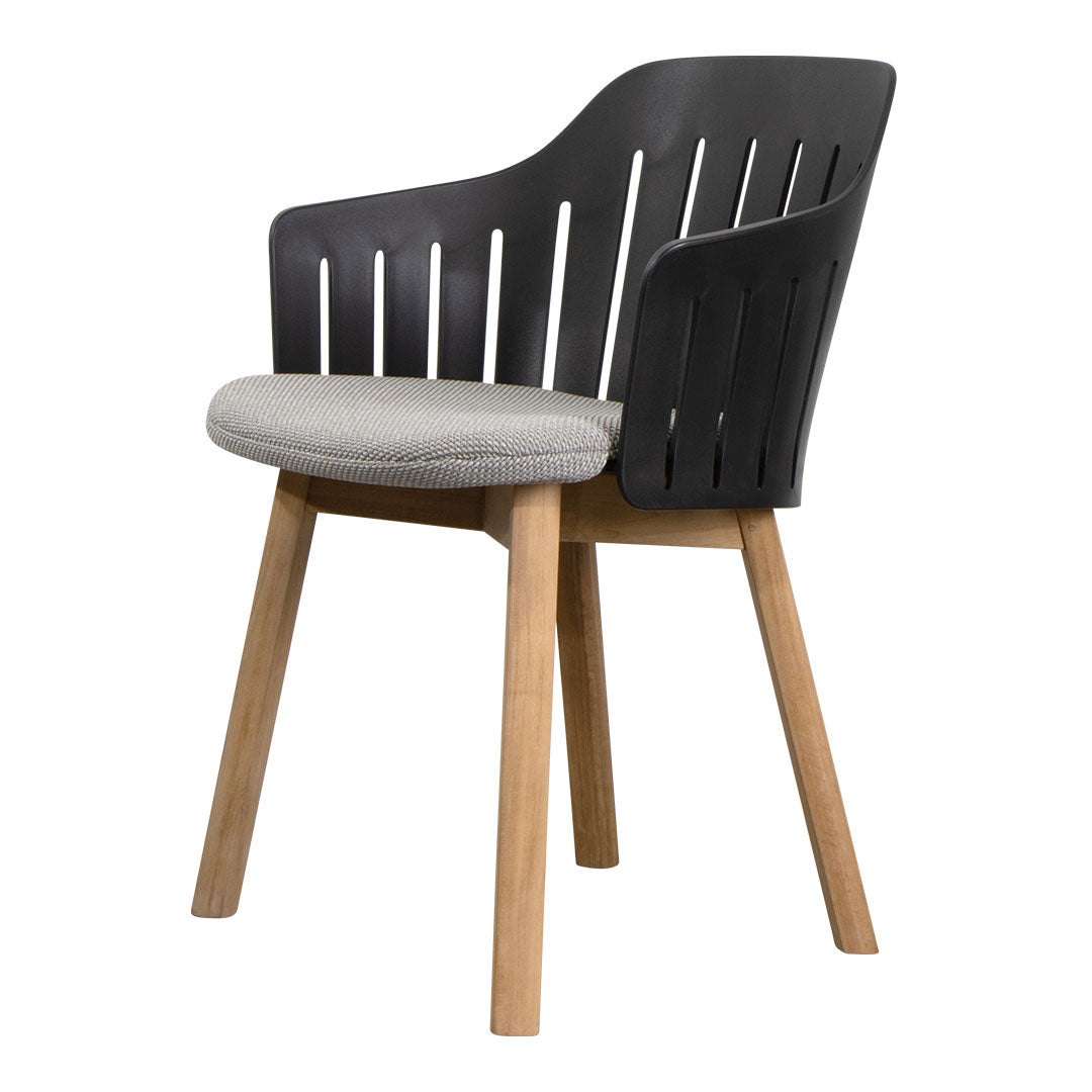 Black slatted chair with gray cushion and light wood legs, featuring a modern and sleek design.