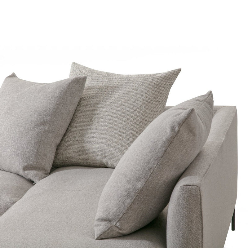 Light gray sofa with textured fabric and plush, varied gray cushions, designed for contemporary living spaces.