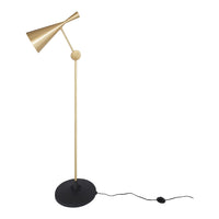 Gold metal floor lamp with a sleek black base and geometric cone shade. Modern design with minimalist aesthetic.