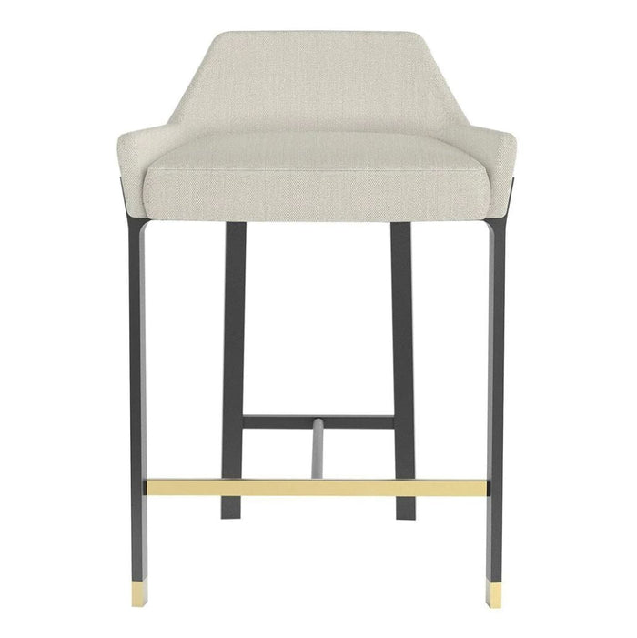 Light gray upholstered barstool with black metal legs and gold accents. Modern design with a minimalist aesthetic.