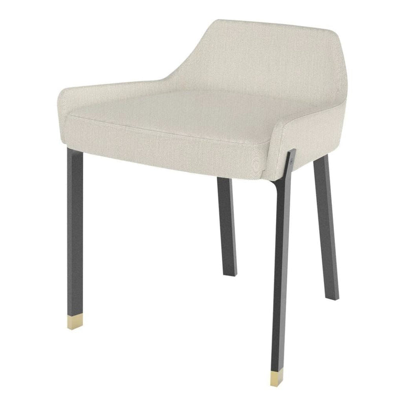 Cream upholstered chair with sleek black legs and gold accents, featuring a modern minimalistic design.