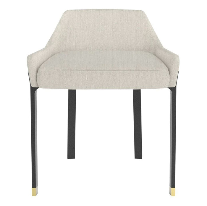 Beige upholstered chair with sleek black legs and gold accents, featuring a minimalist design. Perfect for modern decor.