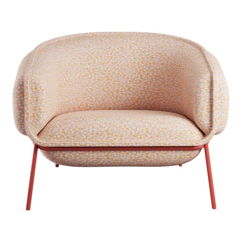 Peach upholstered chair with textured fabric featuring yellow and white speckles on a sleek red frame.