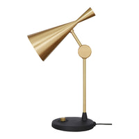 Gold metal lamp with a sleek, modern design and a black base, featuring smooth lines and a minimalist aesthetic.