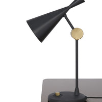 Black and gold modern desk lamp with angular shades and a circular base, showcasing a sleek minimalist design.