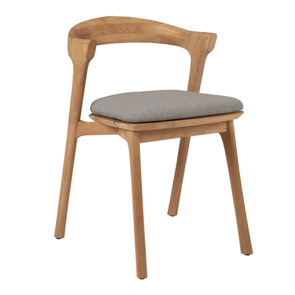 Natural wood chair with a light oak finish and a soft gray padded seat, featuring a simple, modern design.