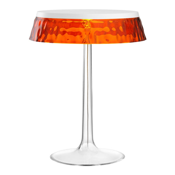 Modern table lamp with a clear base and a vibrant orange, textured shade. Elegant design perfect for any decor.