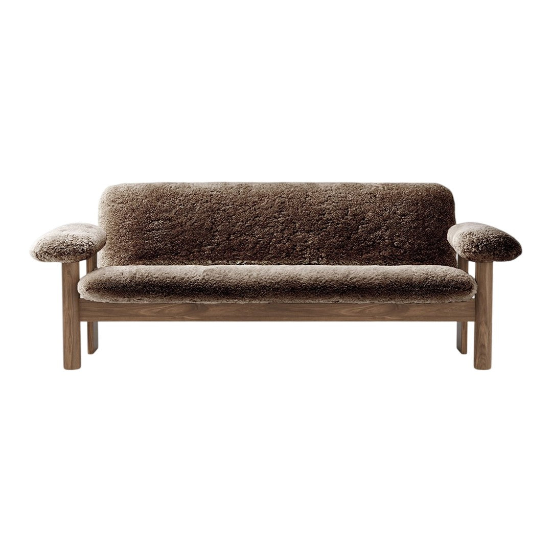 Cozy brown sofa with a textured fabric and light wood frame, perfect for a modern living space.