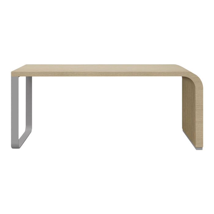 Modern beige tabletop with a sleek silver metal base, featuring a minimalist design and smooth, curved edges.