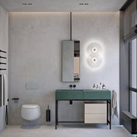 Modern bathroom design featuring a sleek green vanity, neutral tones, and minimalist patterns in a textured gray environment.