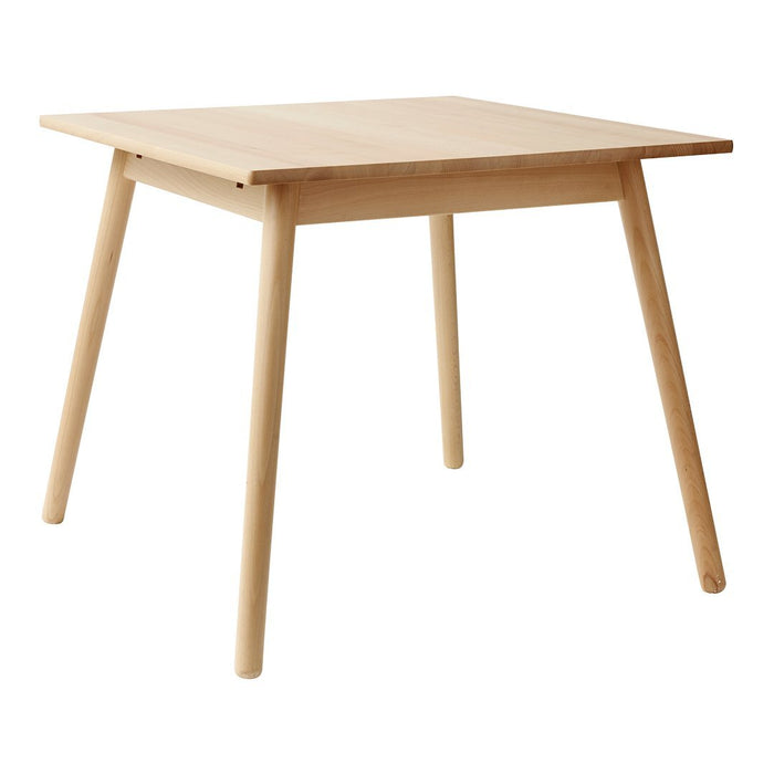 Light natural wood dining table with simple design and smooth finish, perfect for modern decor.