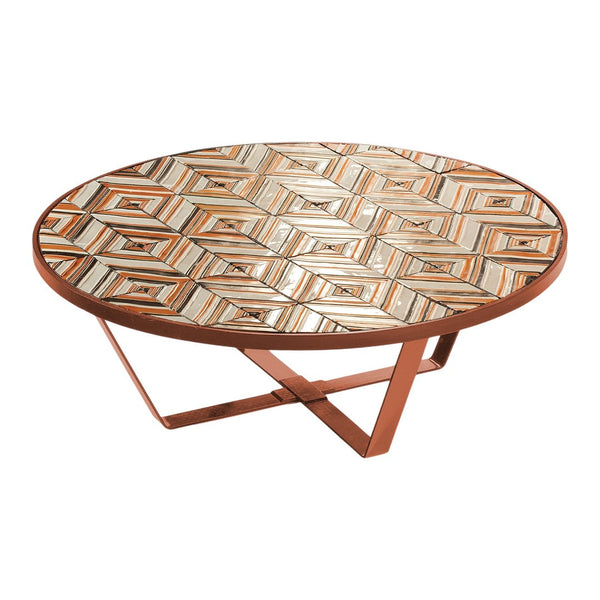 Round coffee table with a geometric patterned top in earthy tones of brown, cream, and orange. Sleek metal base.