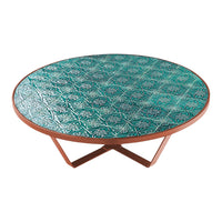 Round coffee table with intricate teal pattern and a copper base, perfect for vibrant home decor accents.