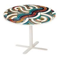 Colorful round table featuring swirling patterns in red, blue, green, and white on a sleek white base.