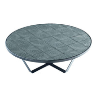 Round coffee table with a textured gray surface and geometric patterns, set on sleek black metal legs.