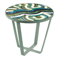 Colorful round side table with swirling patterns in teal, green, blue, and cream. Modern design with sleek metal legs.