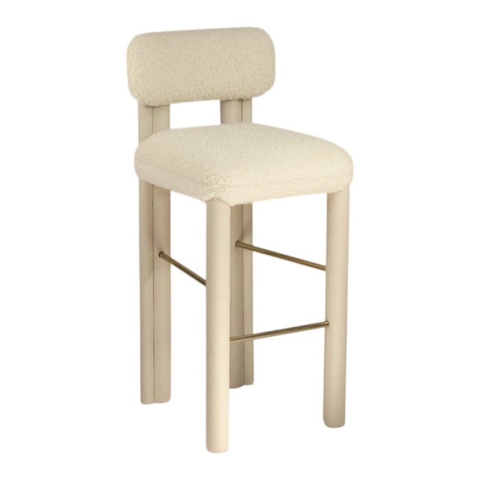 Cream-colored bar stool with a soft, textured fabric and minimalistic wood frame, featuring subtle gold accents.