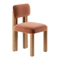Rust-colored velvet chair with light wood legs, featuring a minimalist design and soft, rounded edges.