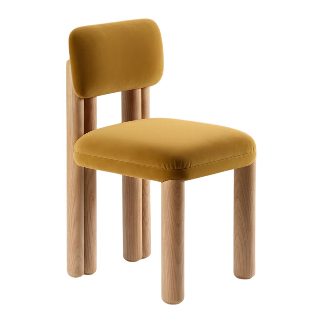 Yellow velvet chair with rounded backrest and natural wood legs, designed for a modern aesthetic.