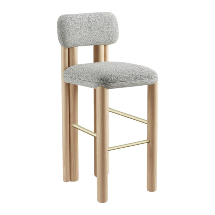 Light gray upholstered bar stool with minimalist design and natural wood finish, featuring a gold-toned footrest.