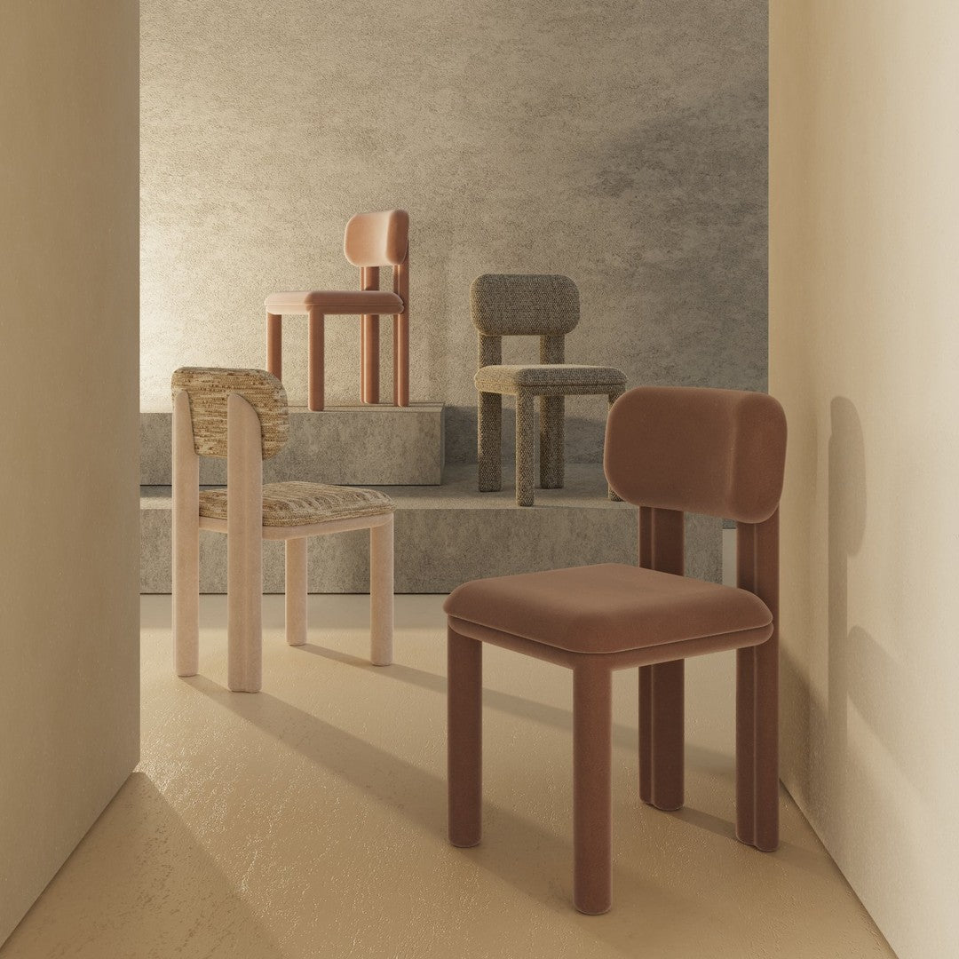 Colorful chairs in earthy tones of brown, gray, and beige with textured fabrics and smooth finishes, arranged artistically.