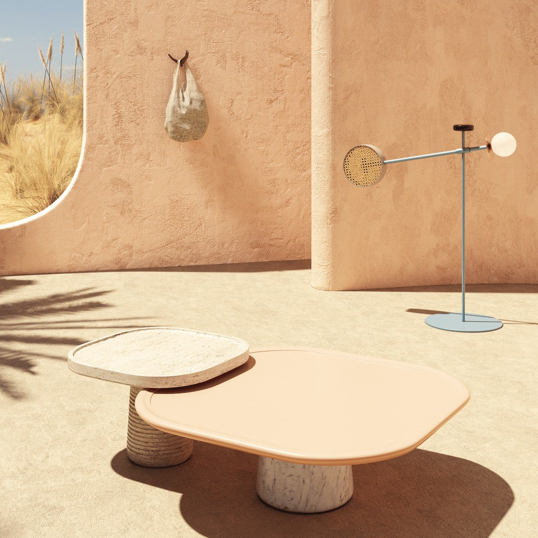 "Stylish abstract coffee table in soft peach and white, showcased against a warm beige background with natural textures."