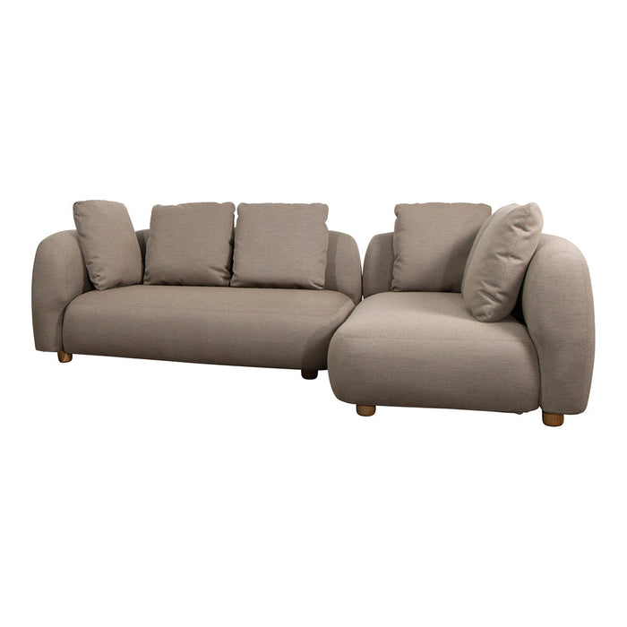 Beige sectional sofa with rounded edges and soft cushions. Cozy, modern design perfect for any living space.