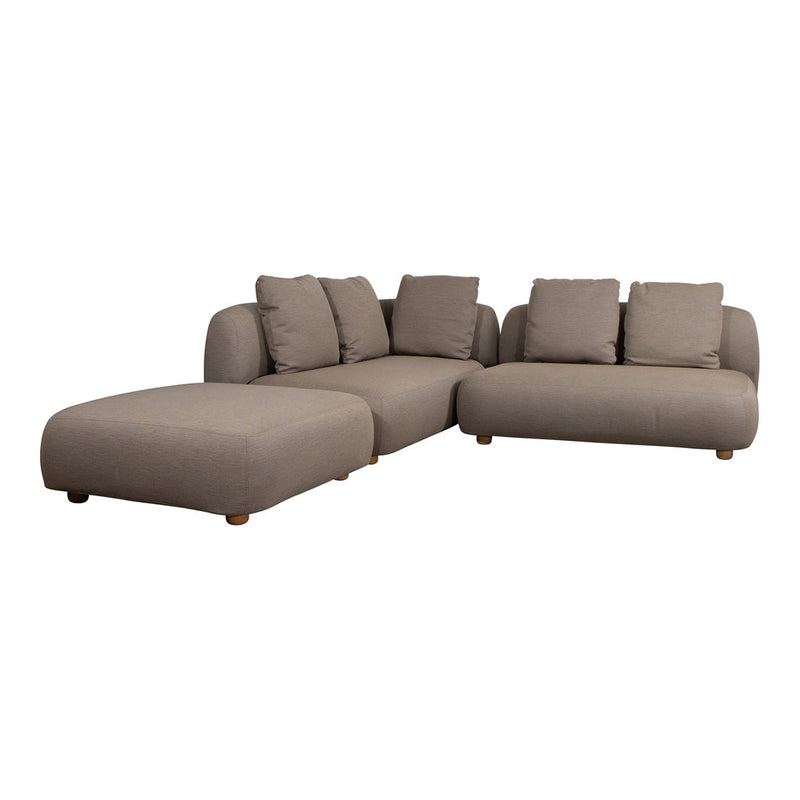 Beige sectional sofa with smooth fabric and plush cushions, featuring a minimalist modern design and rounded edges.