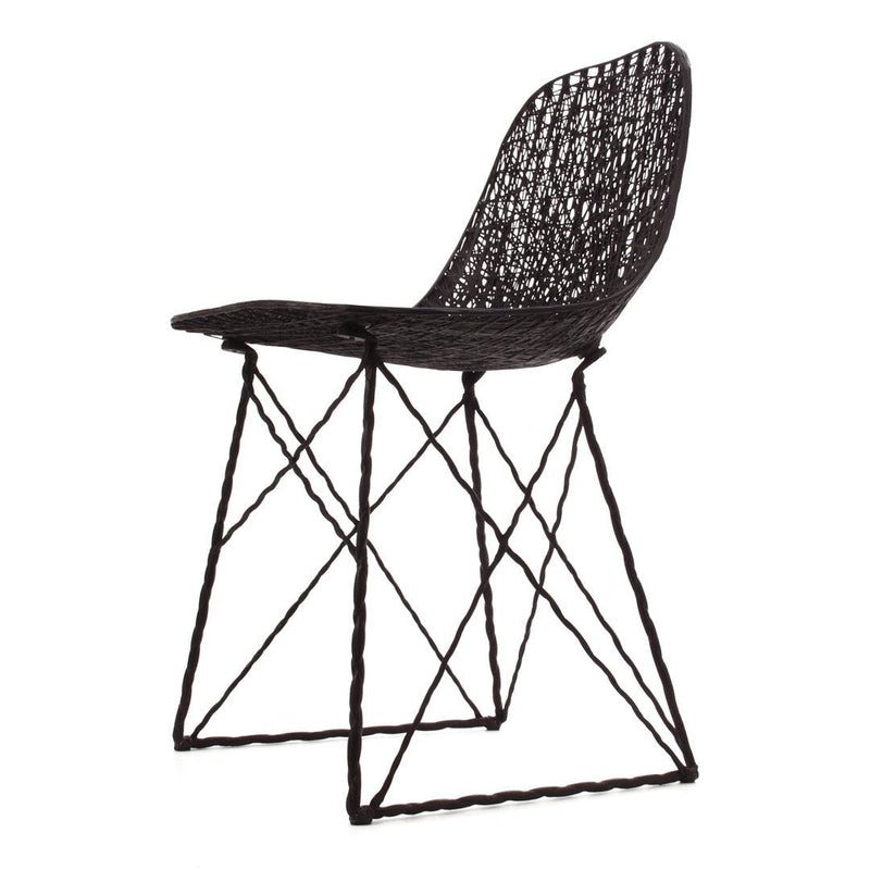 Black woven chair with a geometric pattern and slender black metal legs. Stylish and modern design for any space.