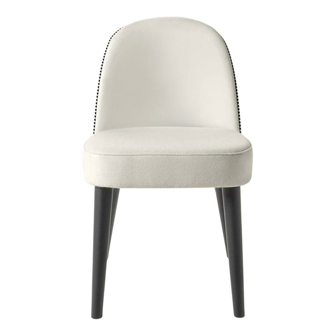 Elegant cream chair with subtle black nailhead trim and sleek black legs, perfect for modern decor.