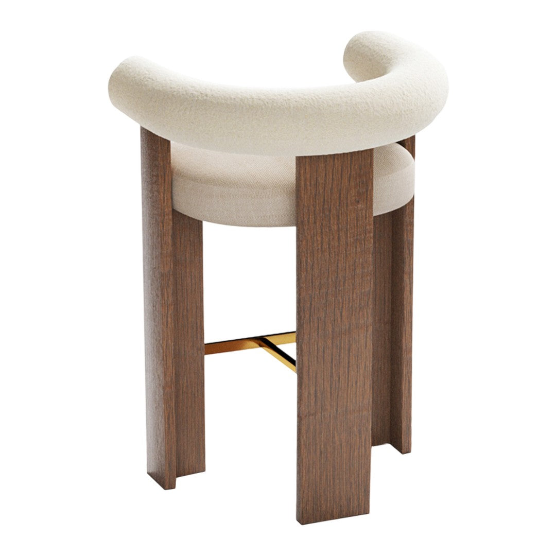Cream curved upholstery with warm wooden legs and a gold accent for a modern bar stool design. Ideal for chic interiors.
