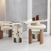 Abstract beige and cream tabletop with black and white patterns, complemented by light wood and soft cream chairs.