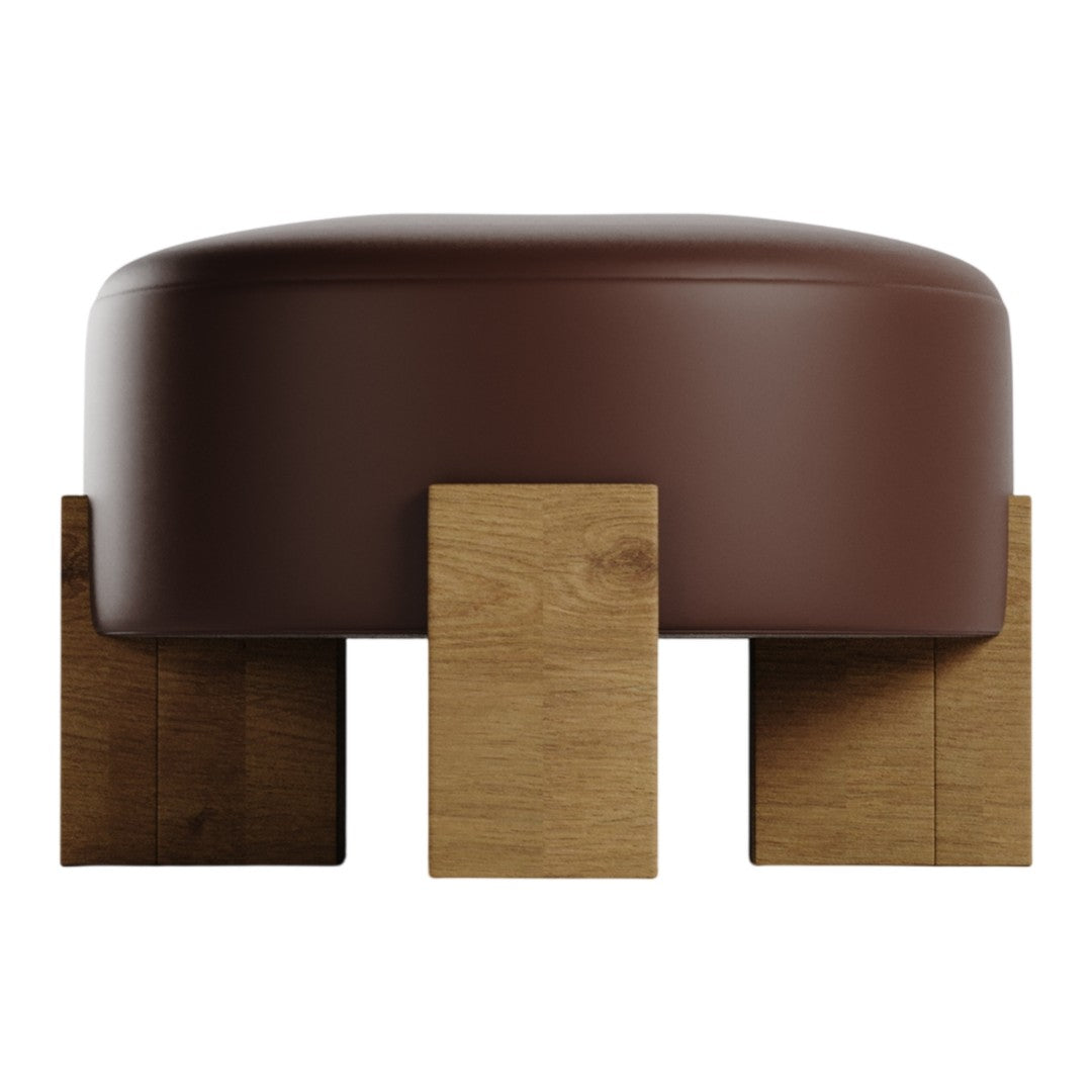 Brown upholstered ottoman with natural wooden legs, featuring a smooth, rounded design and minimalist aesthetic.