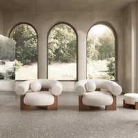 Cream-colored upholstered chairs with rounded shapes and wooden bases, set against a natural backdrop.
