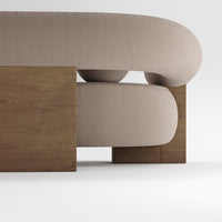Beige rounded sofa with a wooden base, featuring smooth curves and a minimalist design.