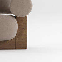 Beige circular upholstery against a warm wood base, showcasing modern design and soft textures.