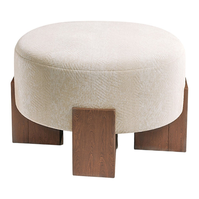 Round beige ottoman with subtle texture, featuring dark wood legs for contrast. Ideal for modern decor.