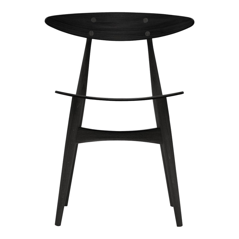 Black wooden stool with a smooth finish and minimalist design, featuring an oval seat and tapered legs.